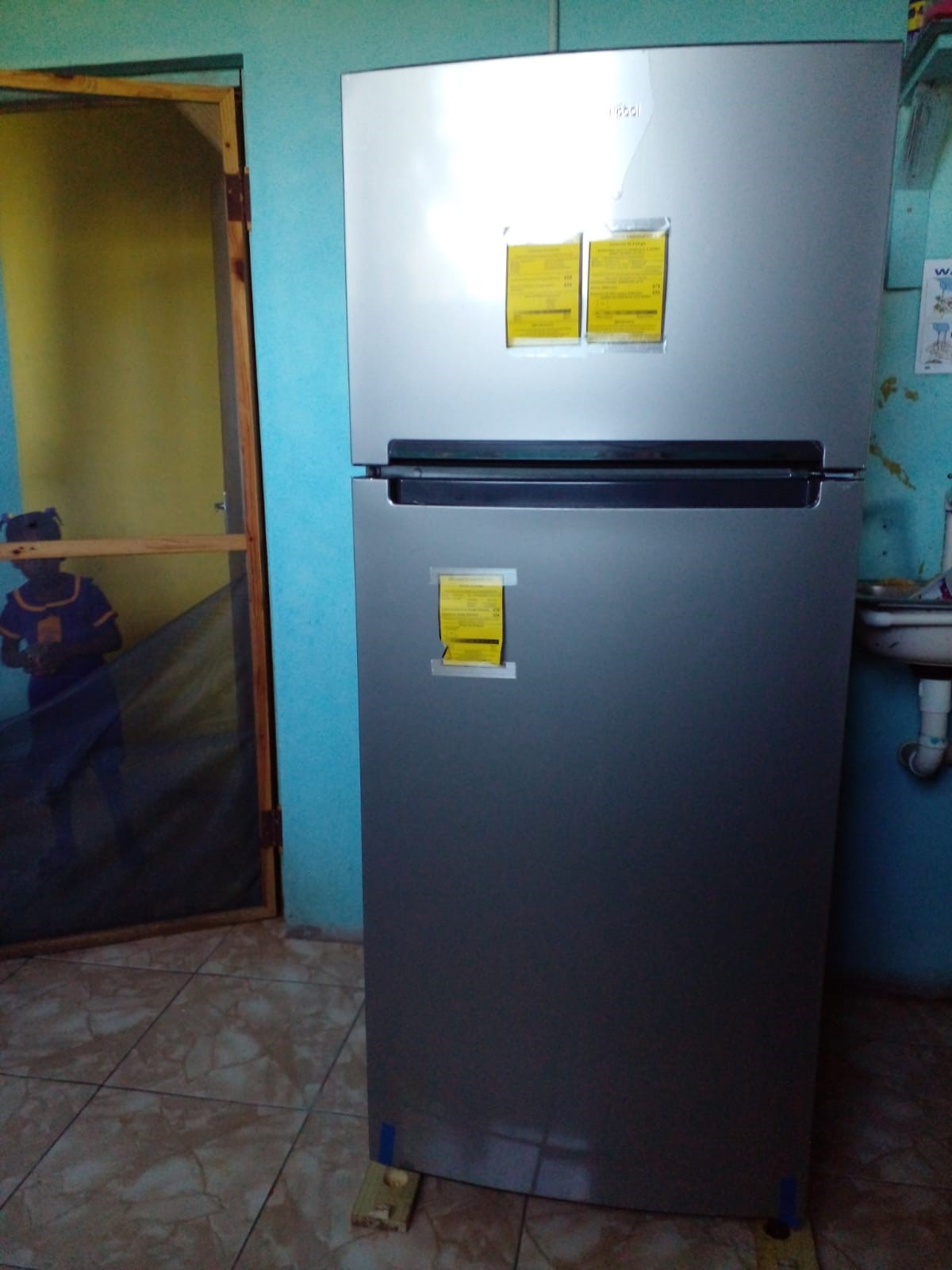 Grace & Staff Donation of a Refrigerator to Beam of Light Basic School